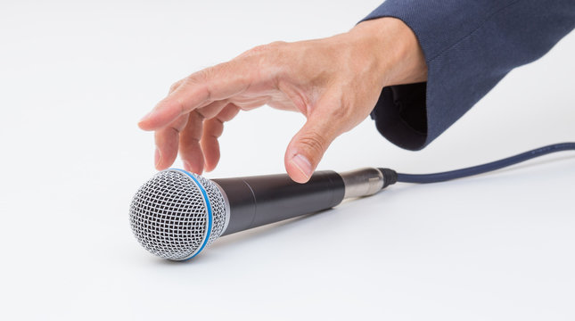 Hand Grabbing Microphone On White Background