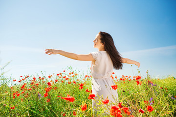 smiling young woman on poppy field