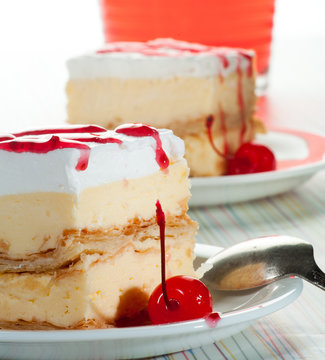 Cremsnit with whipped cream and cherry sauce with cherry juice
