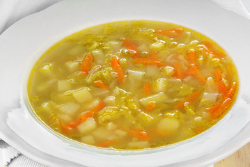 Savoy cabbage soup served in a white plate