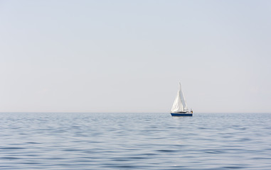 Fototapeta premium Blue sail boat at sea or ocean