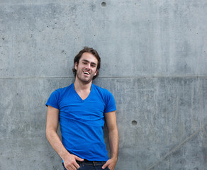 Fototapeta premium Cool guy in blue shirt laughing outside