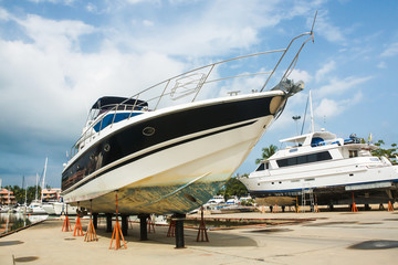 boat on stands in dry dock for repair - 68185098