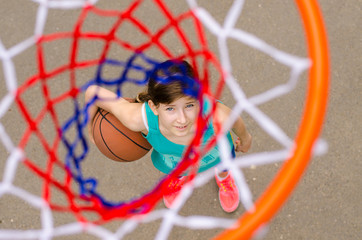 Young girl standing under hoop