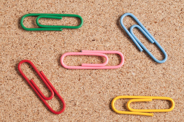 Paper clips on wood.
