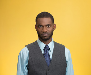Grumpy, skeptical, displeased man isolated on yellow background 