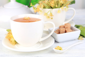 Tasty herbal tea with linden flowers on wooden table