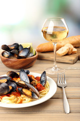 Tasty noodles with mussels on table, close up