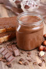Sweet chocolate cream in jar on table close-up