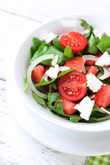 Salad with watermelon, onion, arugula and spinach leaves