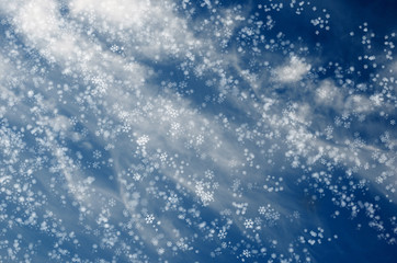 Falling snowflakes on  blue background