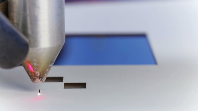 Laser cnc machine cutting square pattern on acryl plate