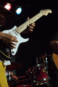 Man playing electric guitar on concert