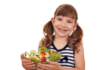 happy little girl holding dish with salad