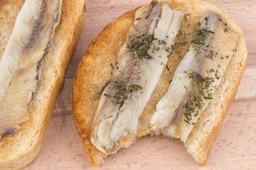Sandwiches with marinated fish on toast