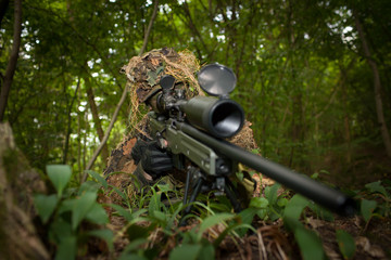 Masked sniper is aiming at the target during the mission