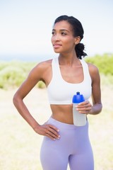 Fototapeta premium Fit woman holding sports bottle smiling