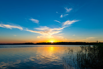 Fototapeta na wymiar tranquil lake and the setting sun over the horizon