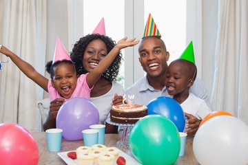 Happy family celebrating a birthday together at table