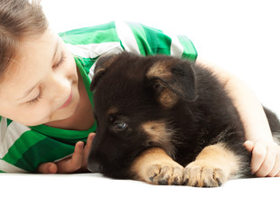 child  gently hugs puppy