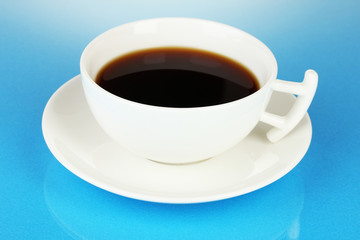 A cup of strong coffee on blue background