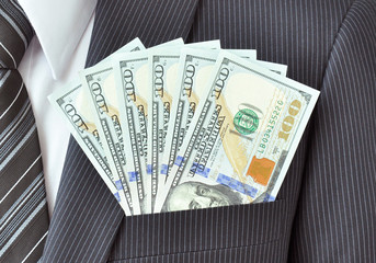 Money - United States dollar (USD) bills in businessman pocket 