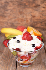 Fresh fruits salad with ice cream in bowl and fruits