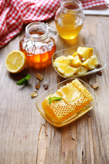 Fototapeta na wymiar Fresh honey and sliced lemon on wooden table