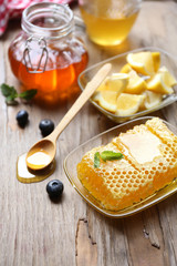 Fresh honey and sliced lemon on wooden table
