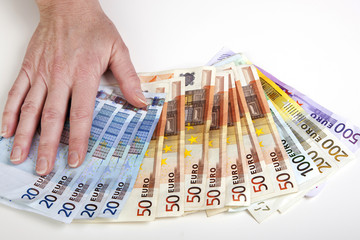 Hand fans out euro bills