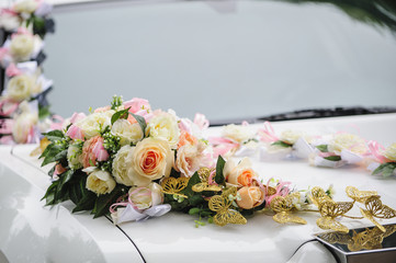 Wedding car decoration of flowers with roses and butterflies