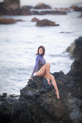 gymnast girl sitting on a stone