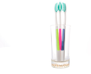 Tooth brush in a glass over white background 