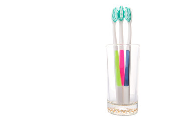 Tooth brush in a glass over white background 