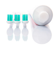 Toothbrush and toothpaste over white background