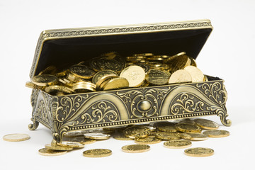 gold casket and gold coins on a white background