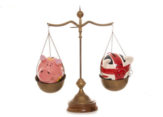 two piggy banks on weighing scales