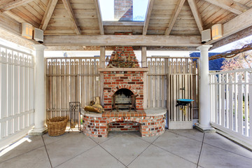 Pergola with brick fireplace on backyard