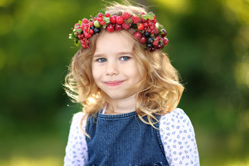 portrait of a beautiful little girl with berries