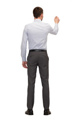 businessman or teacher with marker from back