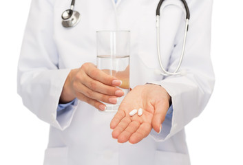 close up of doctor offering pills and water