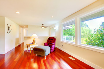 Bright room with antique chair and ottoman