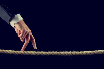 Fingers walking over frayed rope