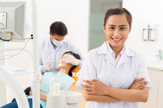 Cheerful assistant of dentist
