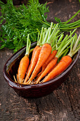 Fresh carrots on old wooden background
