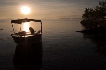 Anchorage speed boat under sun rise