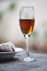 Glass of cognac with Mangosteen standing on a wooden table in su