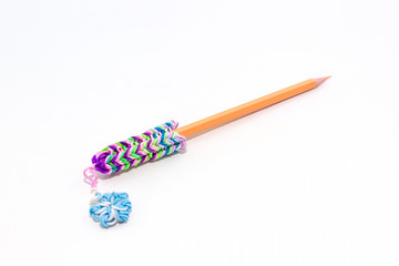 Colorful elastic rainbow loom bands with pencil.