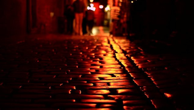 Unknown people on dark street