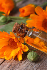 Calendula oil in a glass bottle closeup vertical